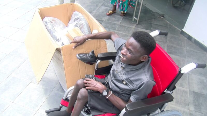 Student who pushes himself 26km weekly to lectures receives 2 electronic wheelchairs, scholarship after JoyNews report