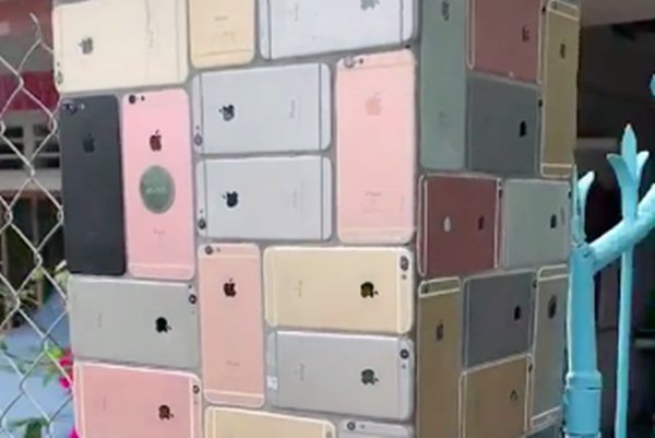 The Ultimate iPhone flex: Hundreds of iPhones used as decorative tiles for house fence