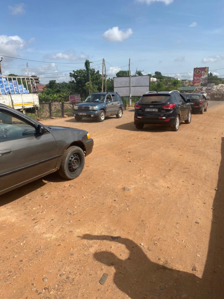Haatso Agbogba commuters cry to government to fix a 10-meter untarred stretch causing severe traffic