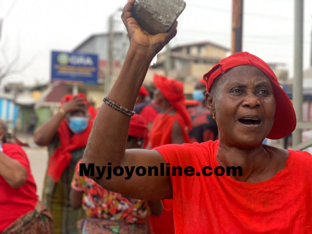 Lady carries blocks meant for Mahama during NDC 'Yentua' demonstration on E-Levy