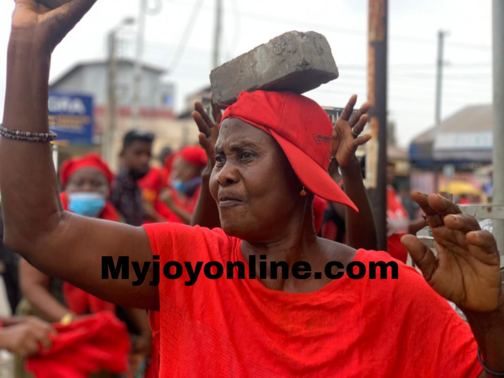 Lady carries blocks meant for Mahama during NDC 'Yentua' demonstration on E-Levy