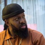 [Video]Timaya falls on stage while trying to lift plus-sized woman during performance