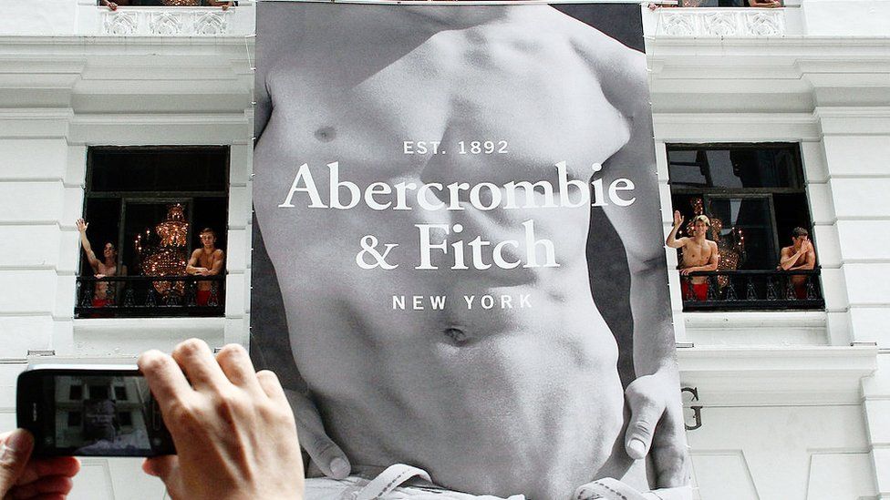 A 2012 file photo showing a store opening in Hong Kong, with a giant banner of a naked male torso emblazoned with the Abercrombie & Fitch logo and shirtless male models waving from the windows