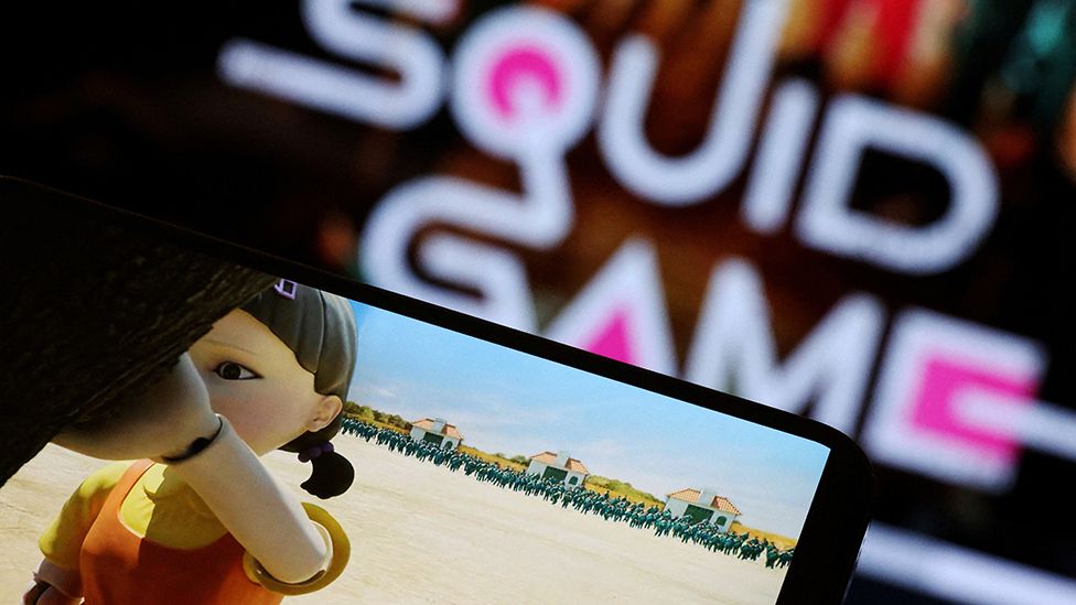 The Netflix series "Squid Game" is played on a mobile phone