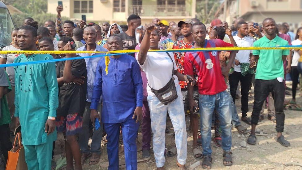 Onlookers at the scene of the blast in Ibadan, Nigeria - 17 January 2024