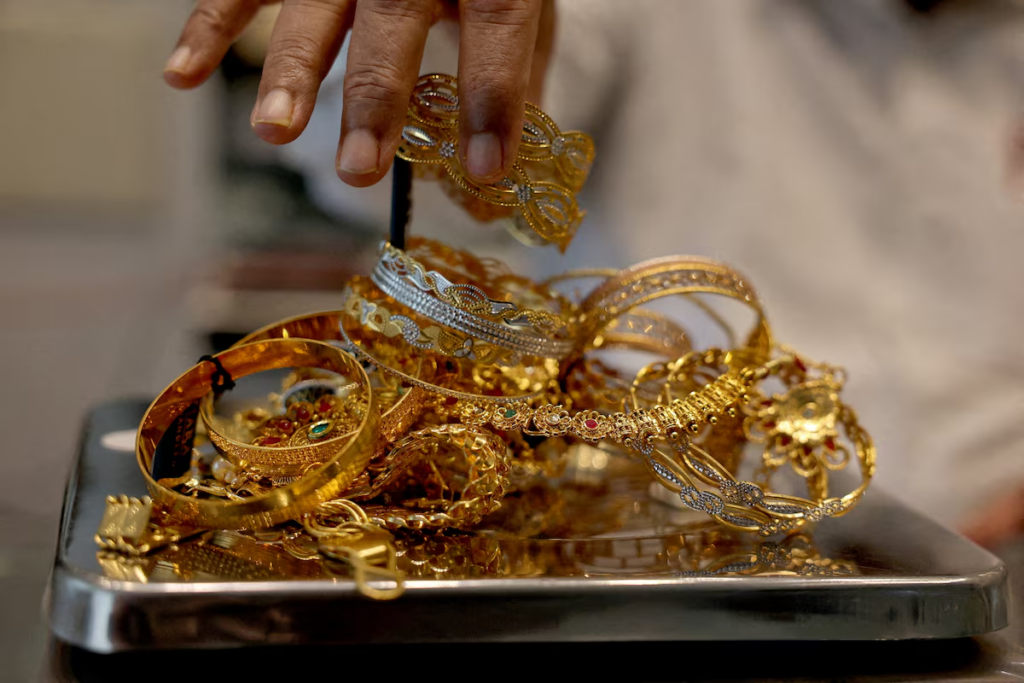 Gold gains on weaker dollar, easing...