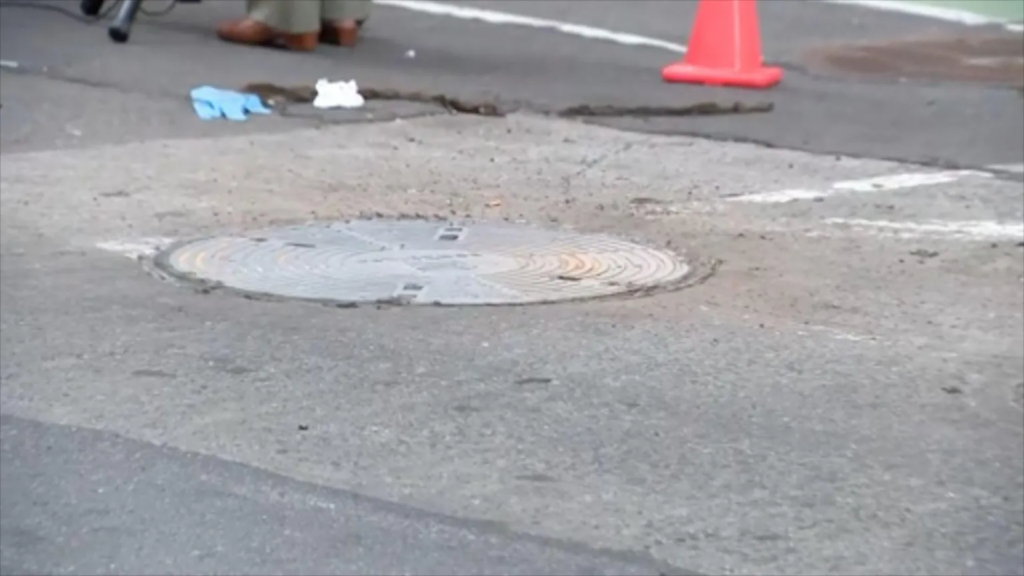 Woman dies after falling into uncovered...