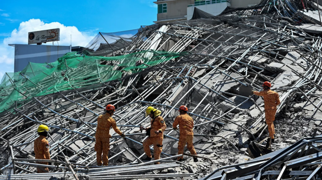 One killed and many feared trapped under...