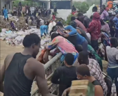 Flood turns disaster into ‘shopping spree’ as residents scramble for warehouse goods washed into gutters