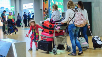 Ryanair says it will reluctantly not charge parents to sit next to children