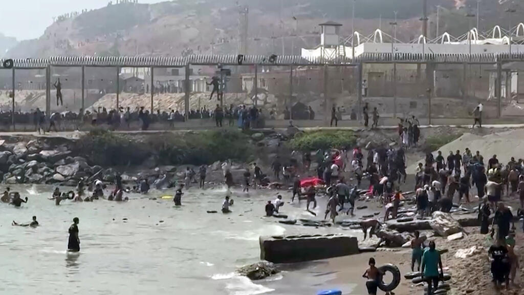 Hundreds of migrants swim from Morocco to Spanish enclave of Ceuta