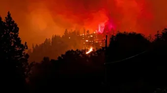Fast-moving Canada wildfire doubles in size forcing thousands to flee homes