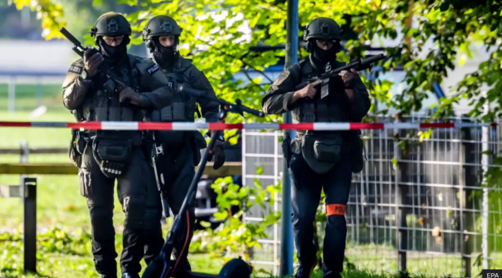 Manhunt after woman, 22, killed and five...