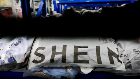 Reuters Packs of clothing are displayed at a garment factory for Shein in Panyu District, Guangzhou