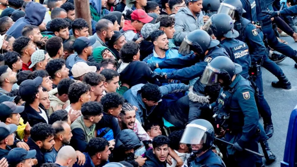 Police begin operation to move migrants...