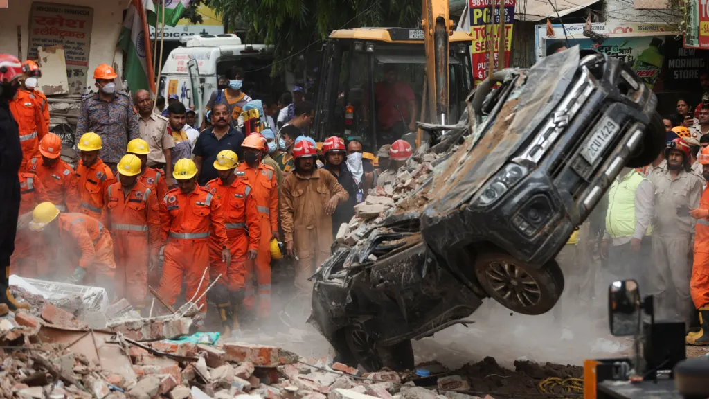 Rescuers dig through debris as seven dead...